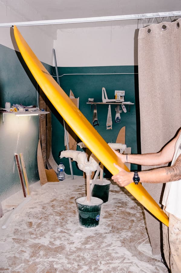 Glassing a surfboard with fiberglass and resin